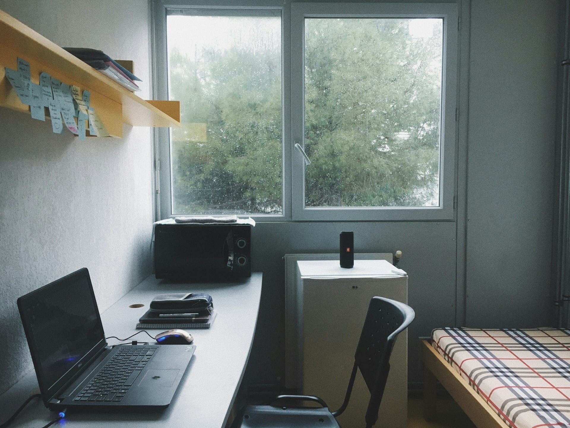 Desk and bed in a small shared employee housing room