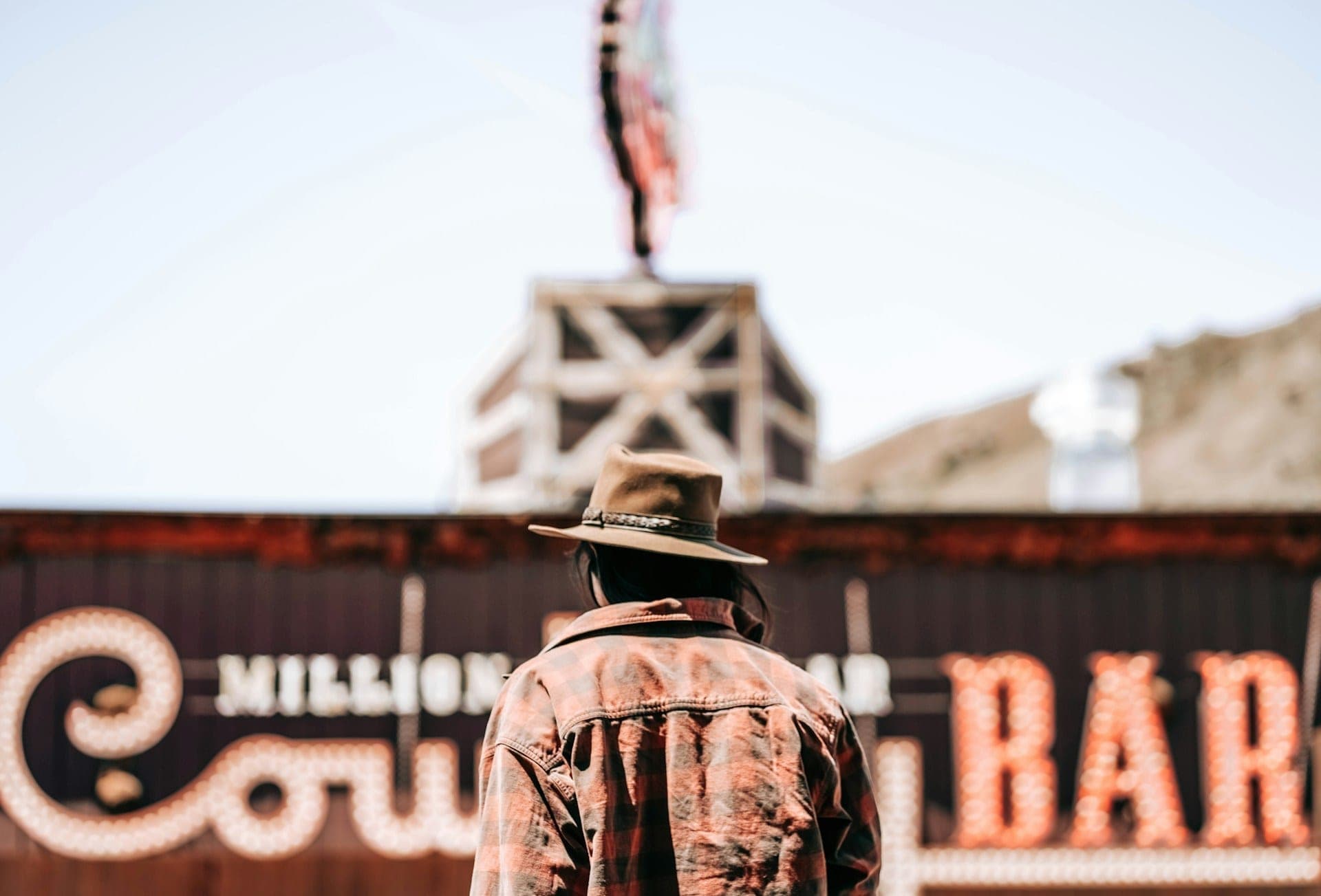 Person in a cowboy hat outside a bar on Jackson town square, Wyoming