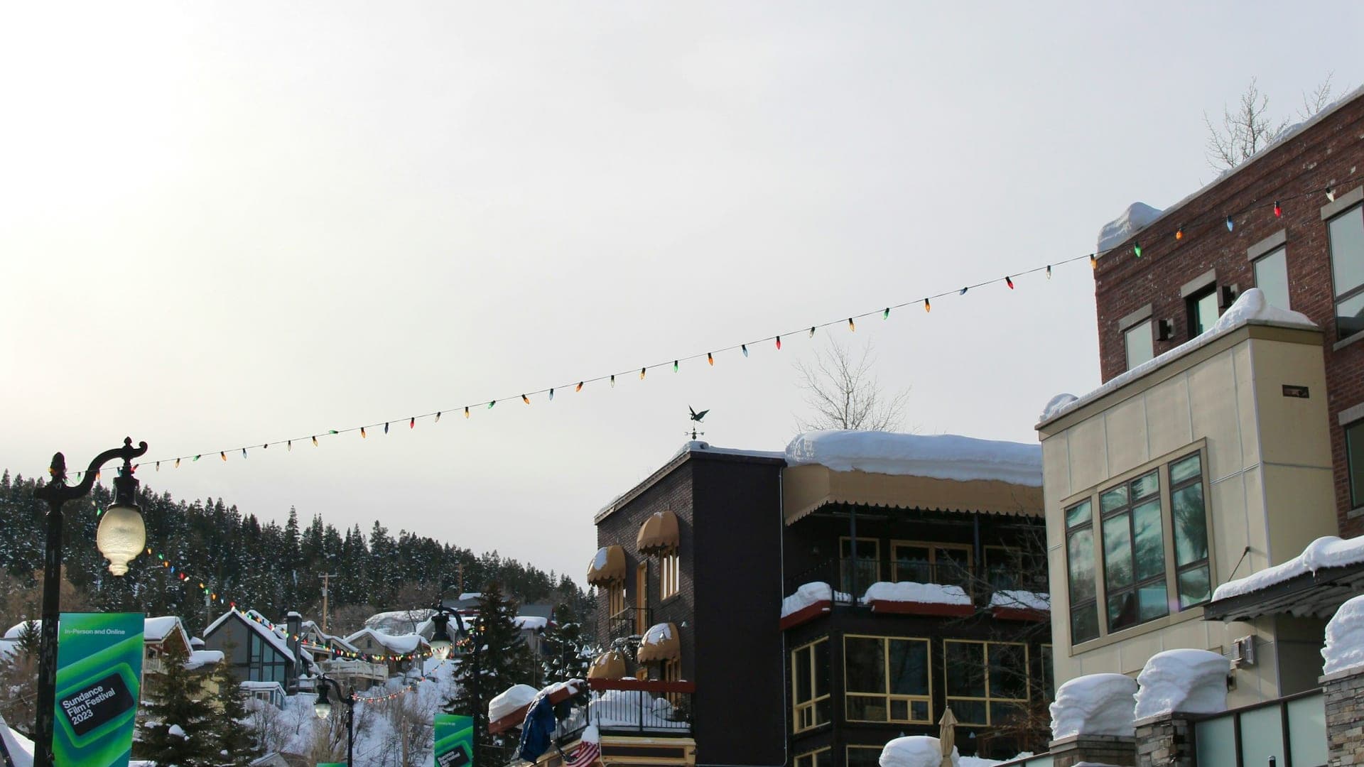 Free city bus pulling up to a snowy ski resort base area in Park City, Utah